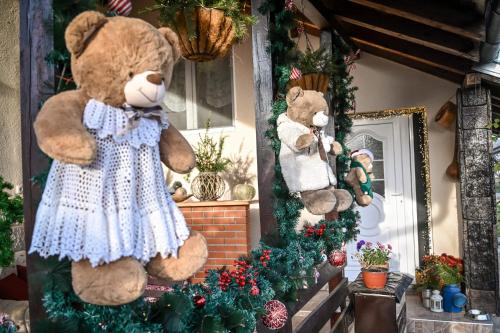 two teddy bears in a room with christmas decorations at Bukovički mir in Arandjelovac
