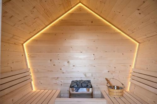 a wooden sauna with a stove in it at Bukovički mir in Arandjelovac