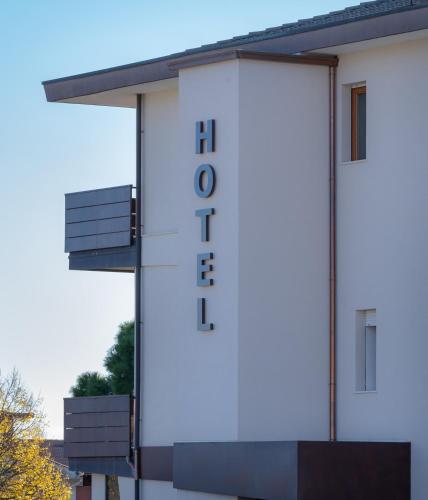 a white building with a sign on the side of it at Hotel Belvedere Thiene in Thiene
