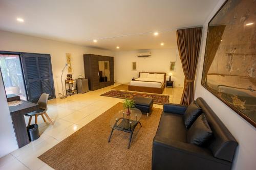 a living room with a couch and a bed at 11 Rooms in Chiang Dao