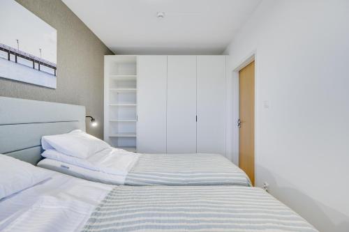 a bedroom with two beds and a window at ReVital Mechelinki by Homeprime Parking Free in Mechelinki