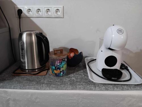 a kitchen counter with a coffee maker and a toaster at Pilve apartment in Võru