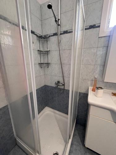 a shower with a glass door in a bathroom at Nefeli luxury apartment in Aronás