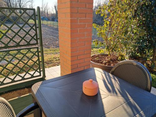 an orange container sitting on a blue table on a patio at Poggio del Poeta in Osmate Lentate