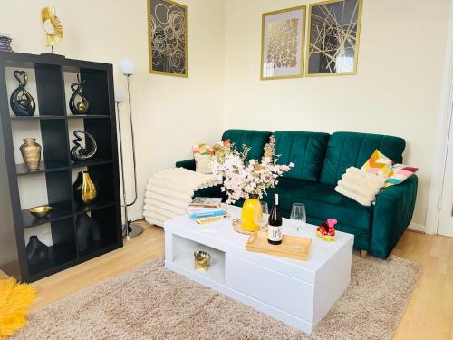 a living room with a green couch and a coffee table at Beautiful Apartment on London Bridge! in London