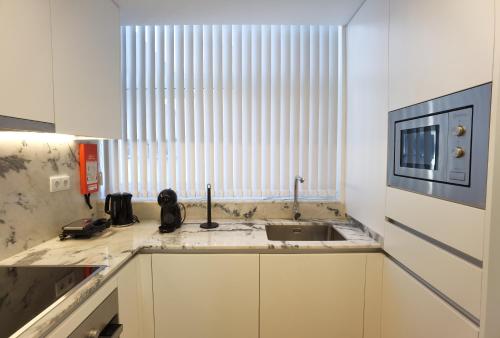 a kitchen with a sink and a window at Sailors Haven in Viana do Castelo