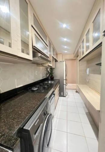a kitchen with a stove and a refrigerator at Apartamento Vista Mar in São Luís