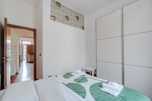 a bedroom with a bed with towels on it at Comfort and Style in Turin - 15 minutes from Piazza Statuto in Turin