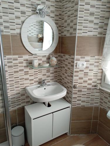 a bathroom with a sink and a mirror at Appartamento Caterina in Cairo Montenotte