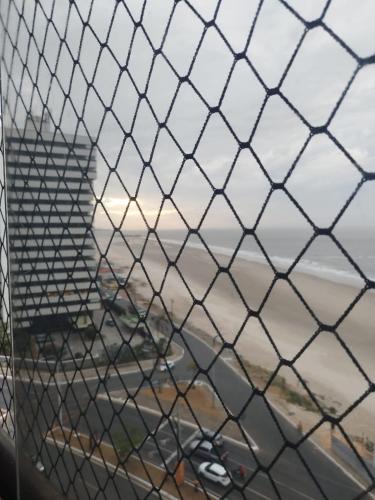 a chain link fence with a view of a highway at Apartamento Vista Mar in São Luís