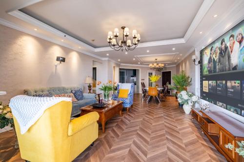 a living room with yellow furniture and a chandelier at Misty Nest High Altitude River View B&B Hongyadong Branch in Chongqing