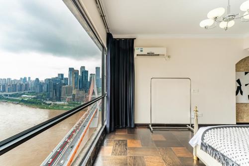 a bedroom with a bed and a view of a city at Misty Nest High Altitude River View B&B Hongyadong Branch in Chongqing