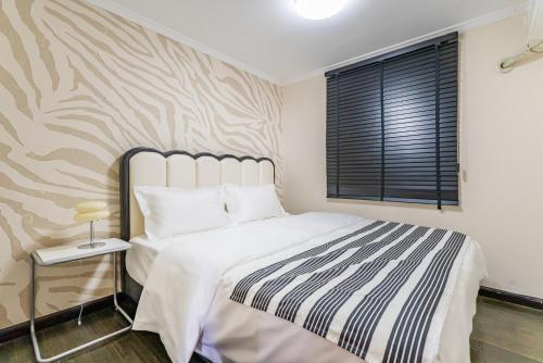 a bedroom with a large bed and a window at Misty Nest High Altitude River View B&B Hongyadong Branch in Chongqing