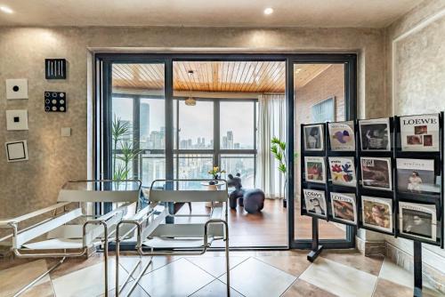 a dining room with a table and chairs and a window at Misty Nest High Altitude River View B&B Hongyadong Branch in Chongqing