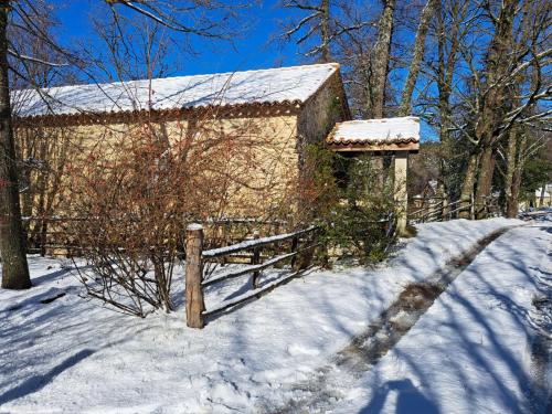 a fence in the snow next to a building at Torre Camigliati Dimora Storica in Camigliatello Silano