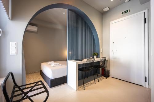 a room with a bed and a table and chairs at Arches Apartments in Athens