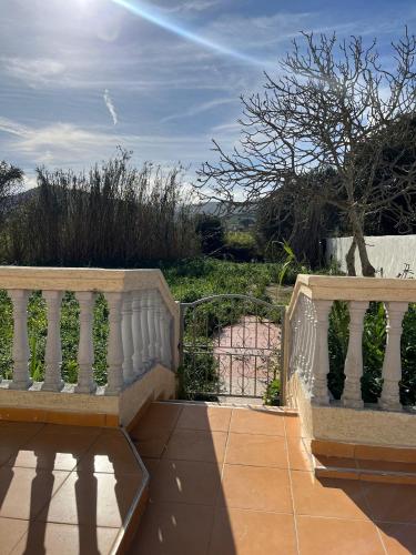 a balcony with two benches and a fence at Villa a oued alien in Tangier