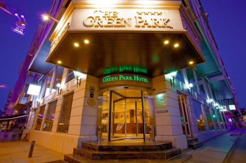 a green park home building at night with lights at The Green Park Taksim in Istanbul