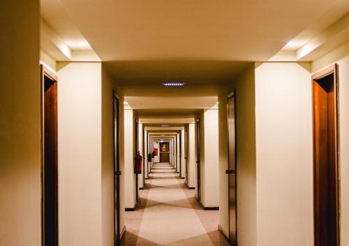 a hallway of a building with a long corridor at Evora Hotel in Évora