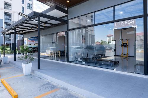 a store front with large glass windows in a city at 44 Residence and Resort in Khlong Luang