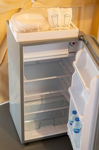 an open refrigerator with its door open and its at 44 Residence and Resort in Khlong Luang