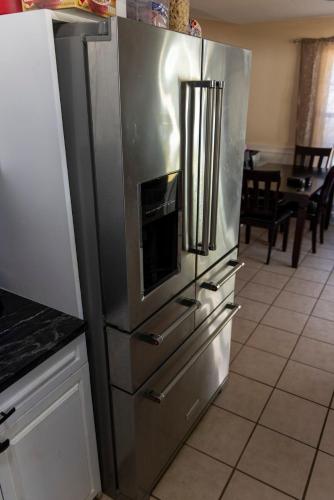 a large stainless steel refrigerator in a kitchen at 12 mi from Parris Island Cozy home in Beaufort