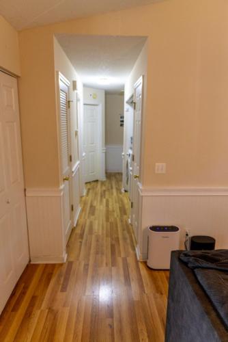 an empty hallway of a home with wood floors at 12 mi from Parris Island Cozy home in Beaufort