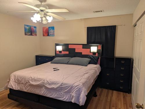 a bedroom with a bed and a ceiling fan at 12 mi from Parris Island Cozy home in Beaufort