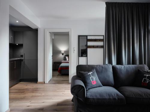 a living room with a couch and a kitchen at Mountain King Chalet in Kitzbühel