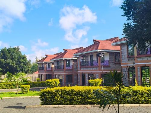 a large brick building with red roof at Balozi Homes Nyeri in Nyeri