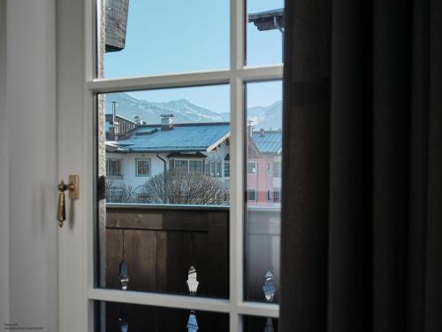 a window with a view of a city at Mountain King Chalet in Kitzbühel