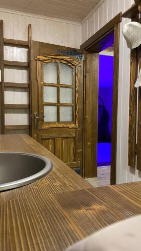 a room with a wooden table and a door at Villa OkSun in Skhidnitsa