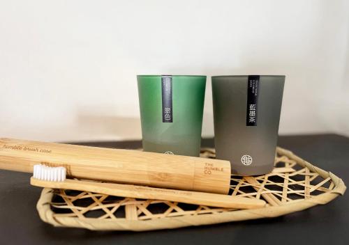 two cups and two wooden sticks on a table at 白馬の黒馬　DarkHorse @Hakuba in Hakuba