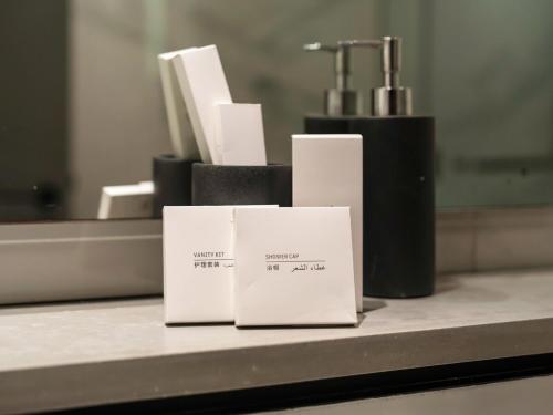 two white cards sitting on a counter in front of a mirror at Downtown Panoramic View in Dubai