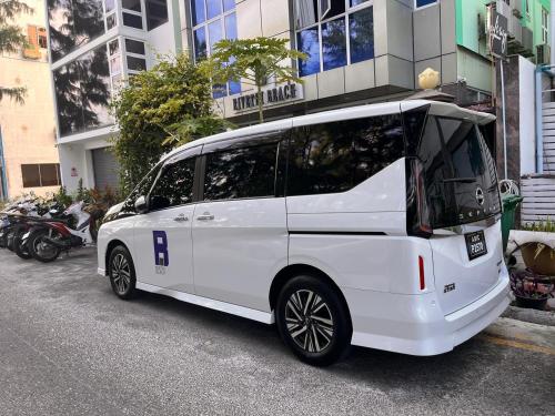 a white van parked in front of a building at Rivethi Beach in Hulhumale