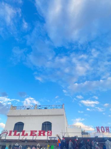a white building with a sign on the side of it at Havana House in Dahab