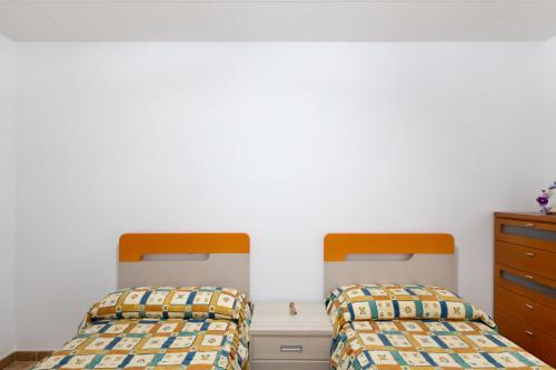 two beds sitting next to each other in a bedroom at Casa Menvil in Sant Jordi de Cercs