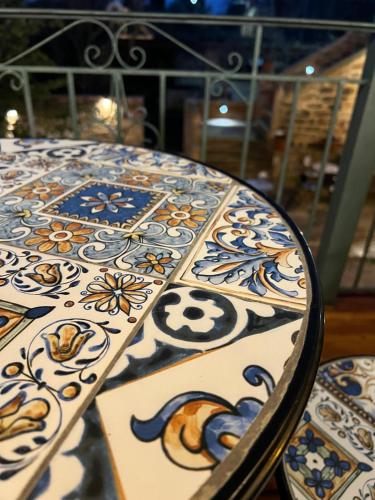 a table with blue and white patterns on it at Pietra Rossa in Chios