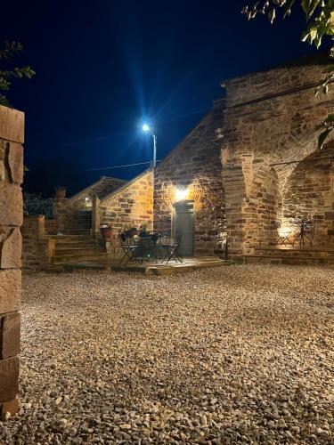 a stone building at night with a street light at Pietra Rossa in Chios