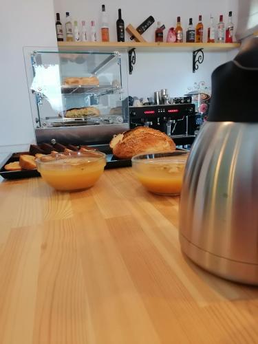 a kitchen counter with bowls of food on a table at Ξαπόσταμα XAPOSTAMA - Ενοικιαζόμενα Δωμάτια in Kalyvia