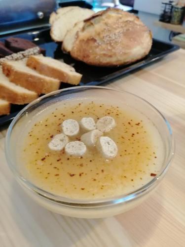 a bowl of food on a table with a plate of bread at Ξαπόσταμα XAPOSTAMA - Ενοικιαζόμενα Δωμάτια in Kalyvia