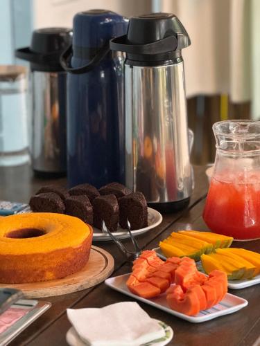 a table topped with plates of food and fruit at Pousada Bela Vista in Ilha do Mel