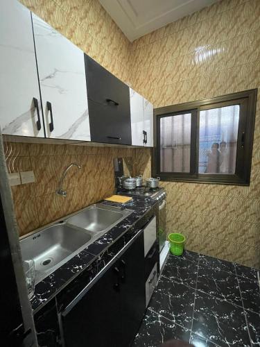 a kitchen with a sink and a counter top at RESIDENCE ORELIO Agoè in Agbéli