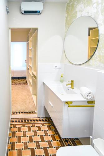 a bathroom with a sink and a mirror at Apartamento Matilde in Ferrol