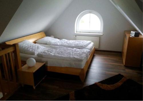 a bedroom with a bed and a window at Seeblick in Fehmarn