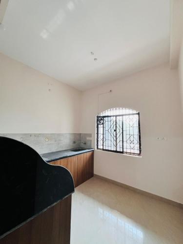 an empty kitchen with a window in a room at Anantam - cozy villa stay in Durg