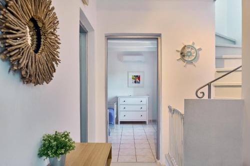 a hallway with a table and a mirror on the wall at Villa Ariadne Periyali in Katastárion