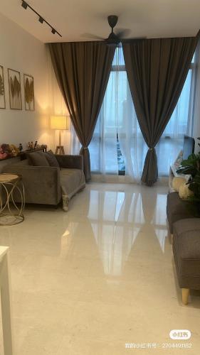 a living room with a couch and a large window at Setia Sky 88 @D'miko Home Stay in Johor Bahru