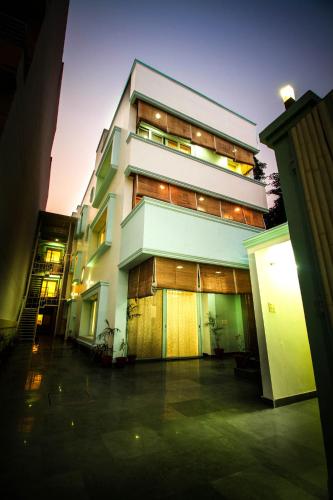 a tall building with a lot of windows at Anara Service Apartments - Greater Kailash Part II in New Delhi
