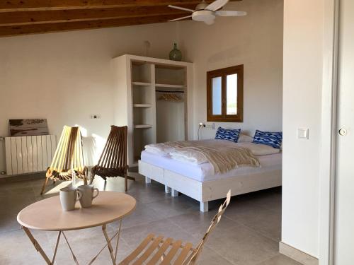 a bedroom with a bed and a table at Blue Door Mallorca in Caʼs Concos